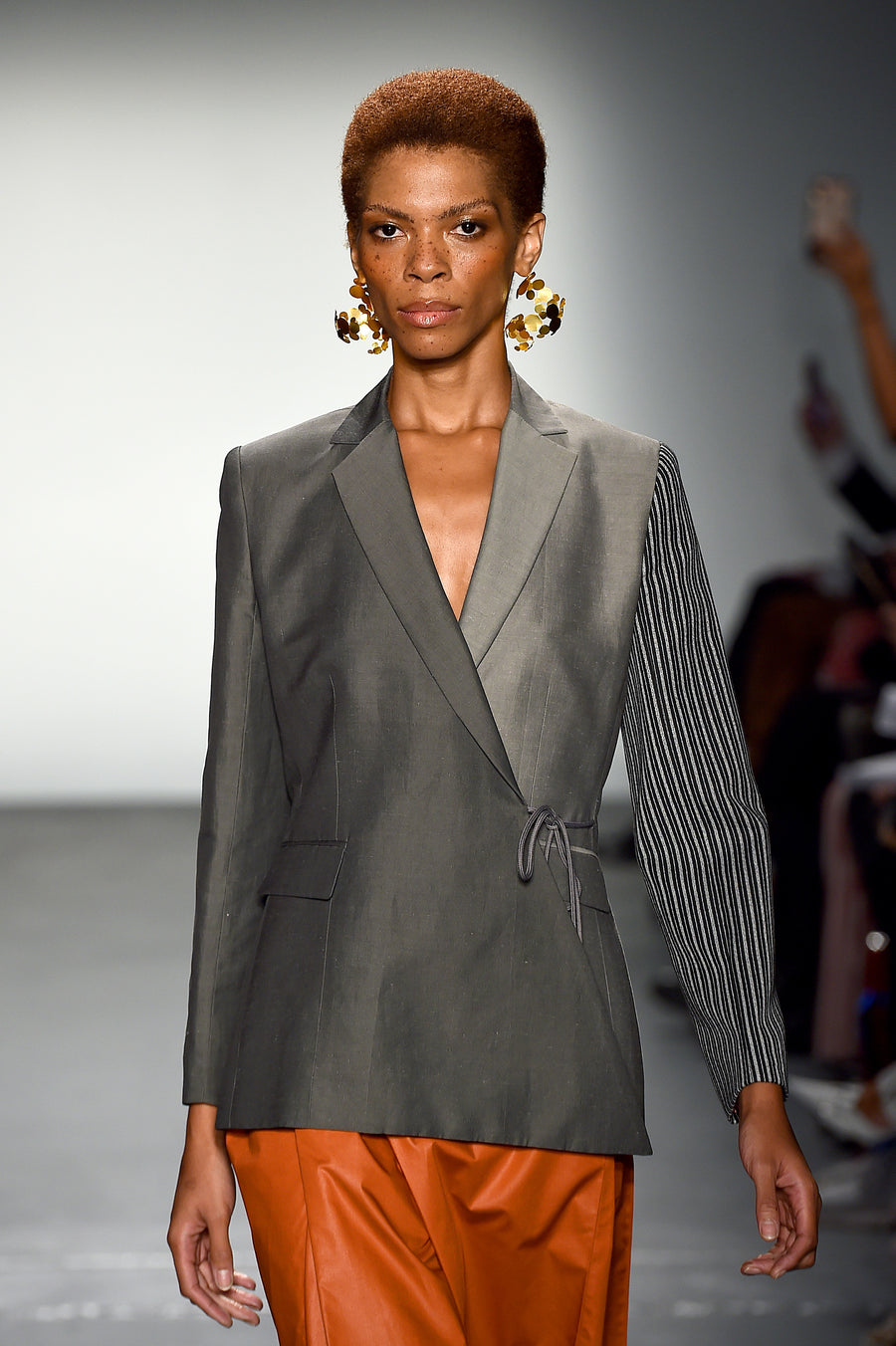 Multi paneled designer gray wrap jacket for women on the runway
