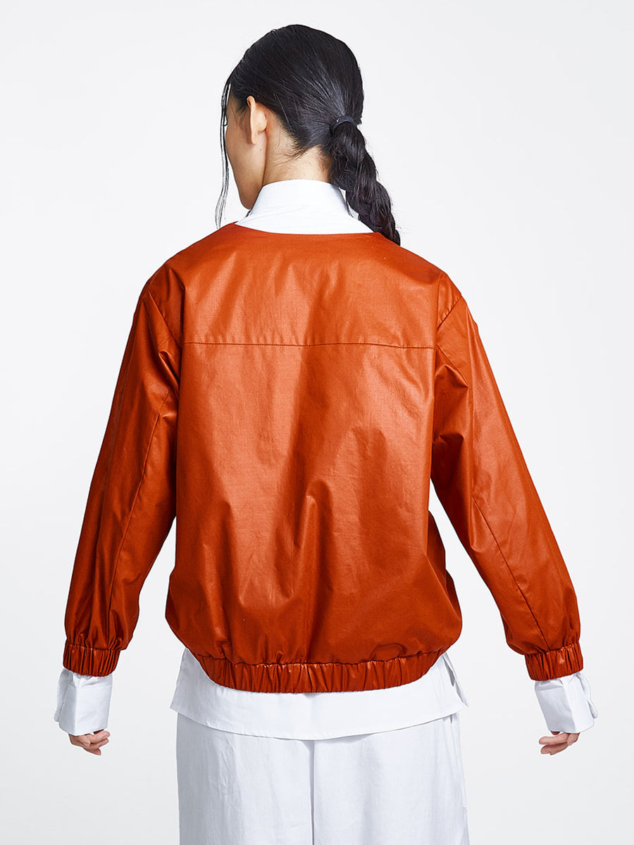 Burnt orange jacket on model back view