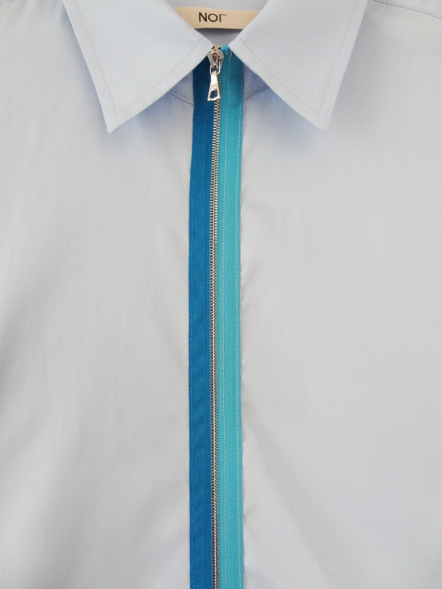 Men's blue cotton collared shirt with blue two-tone metal zipper.