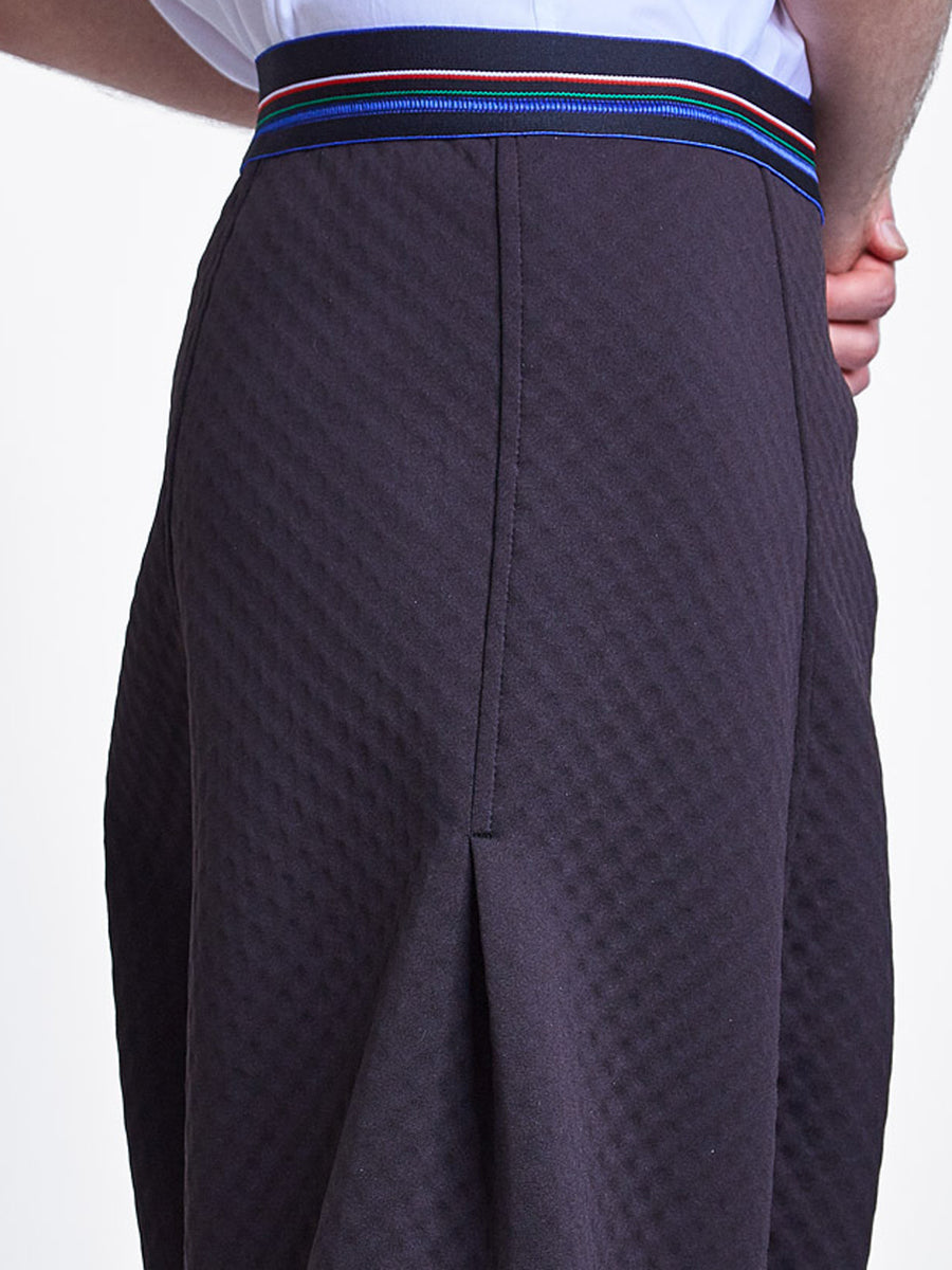 Unisex black bubble neoprene drop crotch pant with striped elastic waistband.