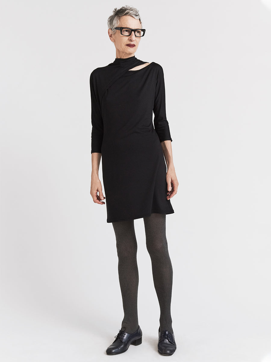 Black jersey designer dress with split dolman sleeves and mock turtleneck.