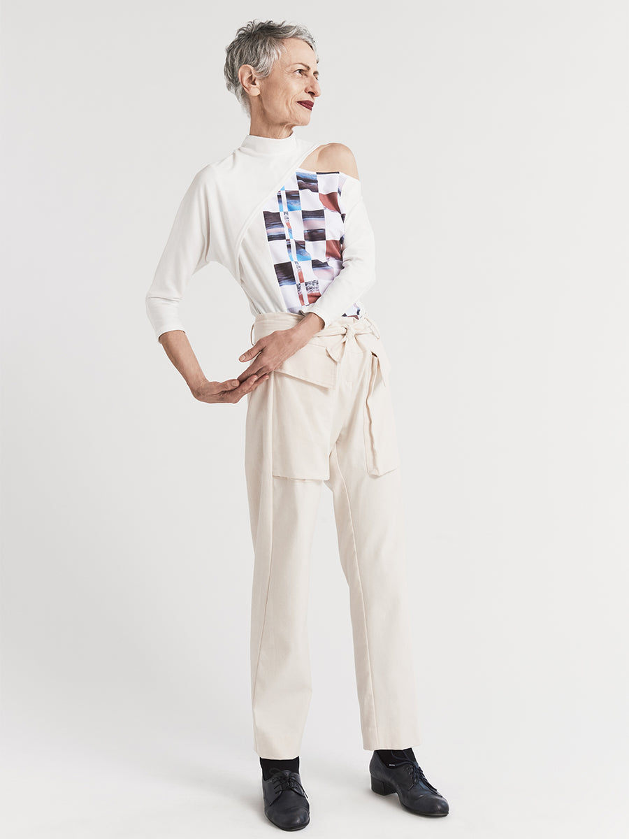 White dolman sleeve top in jersey with original print and mock turtleneck.
